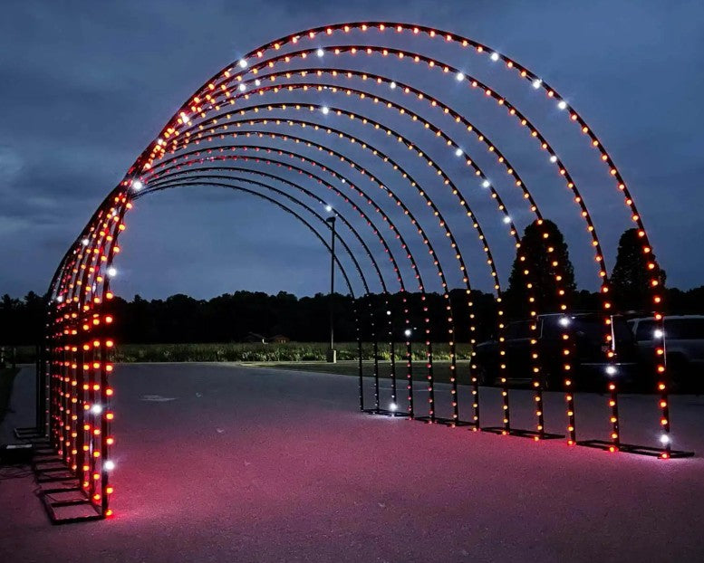 RGB Walk-Through Tunnel Displaying Alternating Red and White Programmable Lights in a Large Arch Tunnel Structure for Holiday Light Shows